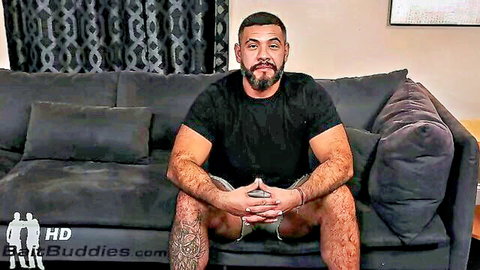 Hairy muscular daddy sitting confidently, bulging in shorts