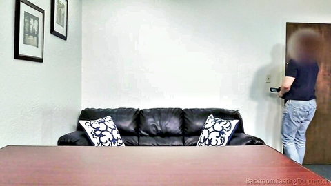 Empty black leather bedroom casting couch setup with blurred man at door ready for ebony petite action