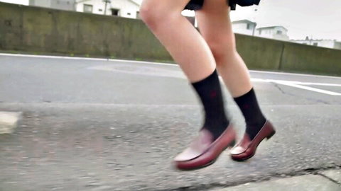 Japanese schoolgirl in uniform jumps upskirt flashing thighs and panties on street