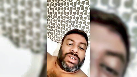 Bearded black man topless in bathroom selfie, honeymoon vibe