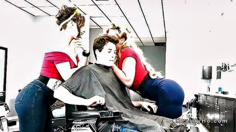 Two busty blonde hairdressers tease young client in salon threesome