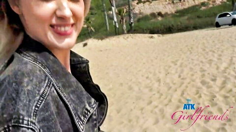 Nicole Nichols smiling on beach in denim jacket, hot POV scene