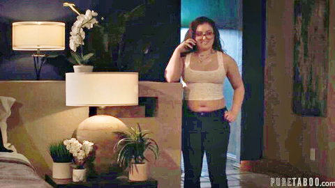 Leana Lovings in cropped tank top and jeans, talking on phone