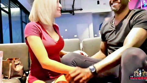 Blonde in red dress holds hands with black man at Mandingo Club VIP
