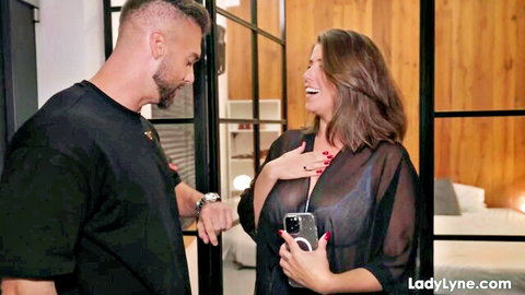 LadyLyne in sheer top flirts with muscular guy holding phone intimately