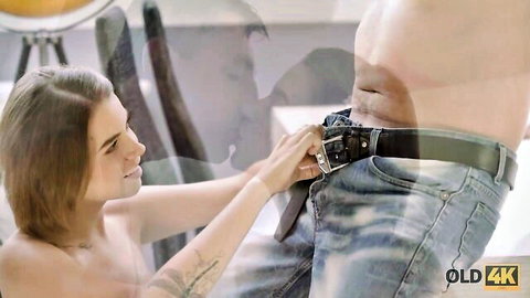 Busty teen undresses mature guy's jeans in intimate foreplay