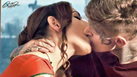 Indian housewife in red saree passionately kissing tattooed man