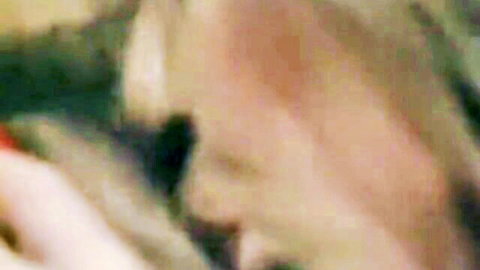 Blurry nostalgic blonde woman in seductive pose, classic porn vibe