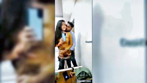 Desi long hair teen girl hugged from behind by lover in orange top selfie