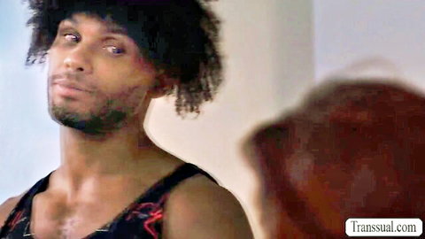 Muscular black BBC stud with afro stares intensely at redhead in transual.com scene