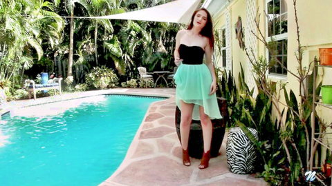 Luci Lovett in sexy black top and green skirt by pool