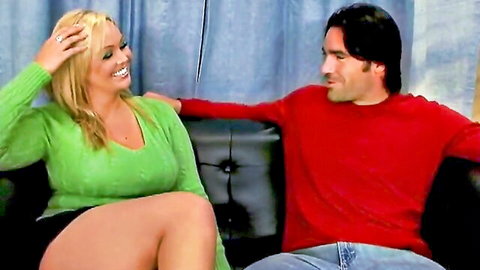 Abbey Brooks in green sweater seduces Charles Dera on couch