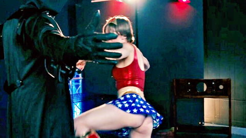 Brunette Wonder Woman cosplay bent over exposing shaved pussy and ass grabbed by cloaked BDSM villain