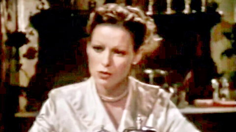 Danielle Martin in elegant white satin blouse and pearls, seductive brothel tease 1982