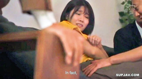 Japanese woman in yellow top roughly grabbed by two suited men on couch in intense threesome setup