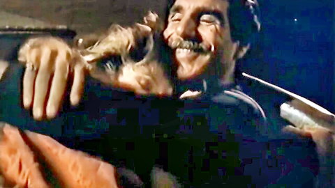 Traci Lords in passionate embrace with mustached partner in vintage adult scene