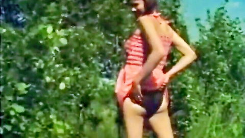 Skinny retro babe bends over outdoors lifting striped dress exposing black panties and ass