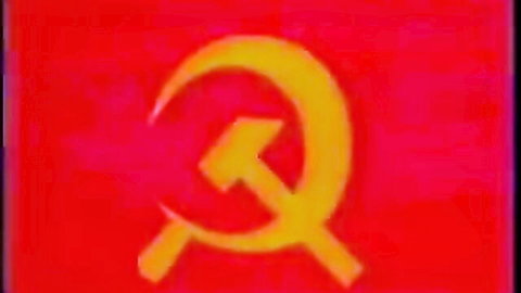 Red Soviet Union flag with golden hammer and sickle emblem
