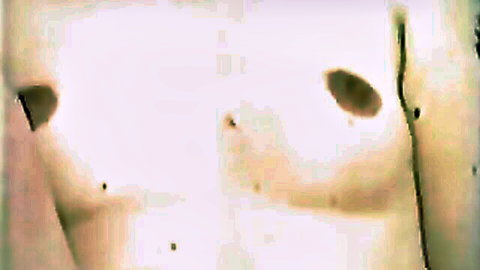 Close-up of pale busty woman's huge perky tits with massive erect nipples