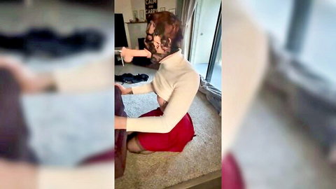 Brunette in dog mask kneeling in turtleneck, red skirt and stockings