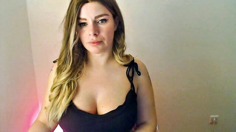 Selina-666 blonde camgirl in black cleavage top, webcam tease