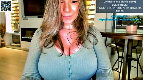 Enna Miller blonde with big cleavage in low-cut green sweater webcam tease