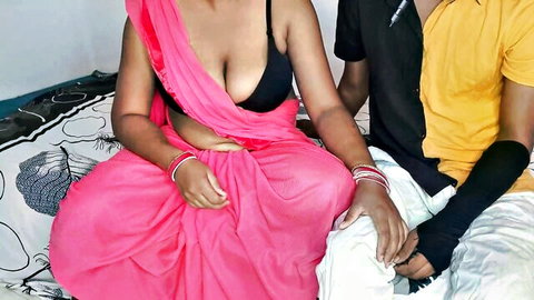Desi Indian bhabhi in revealing pink saree with devar, showing deep cleavage and midriff