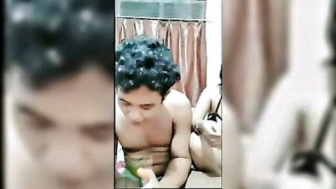Indonesian couple intimate moment on live stream, young man with curly hair