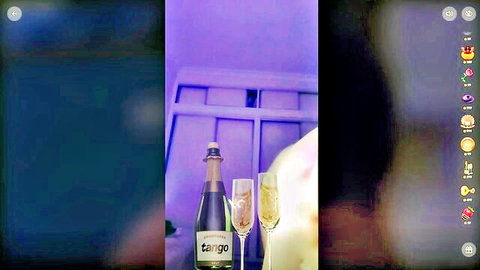 Tango champagne bottle and glasses in dim purple-lit setup