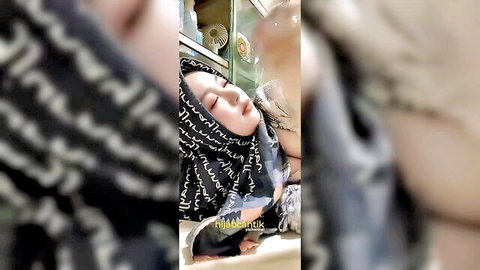 Indonesian hijab MILF eyes closed as lover licks her cheek in homemade tease