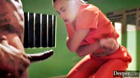 Skinny white prison inmate in orange jumpsuit faces huge black cock in cell
