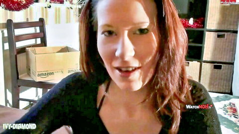 Ivy-Diamond smiling in black low-cut top, festive red hair beauty