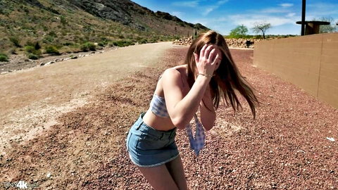 Playful petite redhead teen covering eyes bending over in short denim skirt teasing small ass outdoors