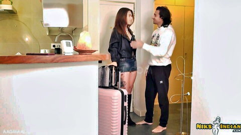 Sexy Indian woman in leather jacket and shorts with man in hotel room entry