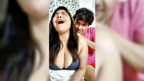 Curvy olive-skinned babe with big tits laughs wildly as boyfriend massages her shoulders from behind