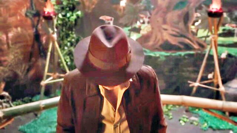 Man in Indiana Jones fedora and leather jacket in temple scene