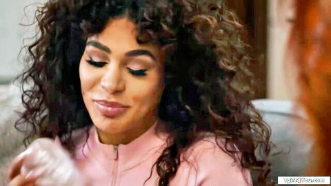 Eva Maxim curly-haired MILF in pink top holds toy, teasing smile