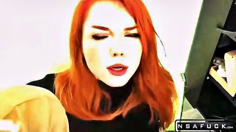 Seductive fiery redhead with glossy plump lips parted teasing blowjob in black top