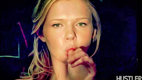 Blonde babe with long hair puckers plump lips in teasing cock-sucking gesture closeup