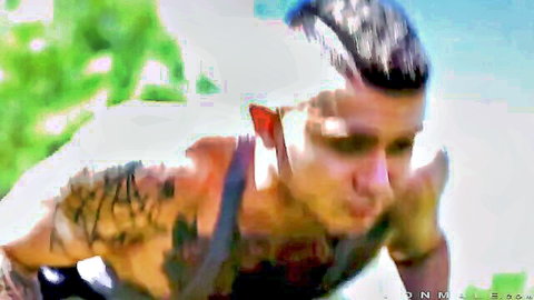 Muscular tattooed Latino man with bandaged shoulder after intense workout