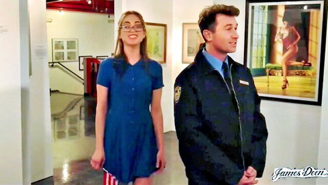 Slim nerdy girl in blue dress with security guard in museum gallery