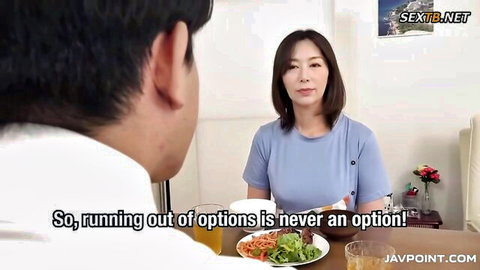 Japanese MILF in blue top chats seductively with man at dinner table in JAV