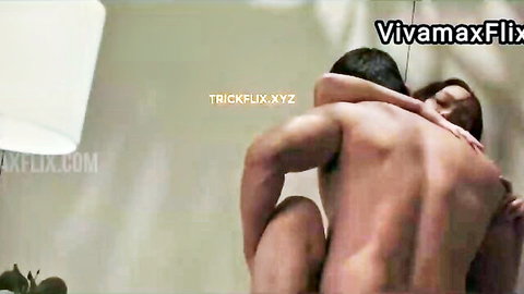 Muscular naked Asian man embraces busty Filipina woman from behind in passionate hug
