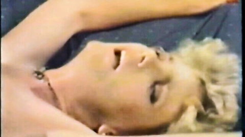 Vintage 1985 blonde in ecstasy, lying back mouth open in retro Bi-Coastal porn scene