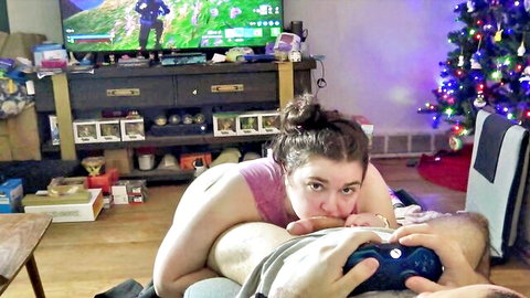 Curvy brunette gamer gives blowjob from behind to guy during video game