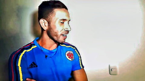 Hot Latino footballer in Colombian jersey, athletic build, seductive pose