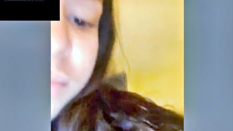 Blurry closeup of Asian teen's ecstatic squinted face moaning in webcam solo masturbation