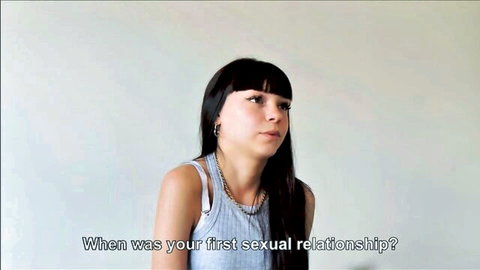 Brunette teen in tank top interviewed about first sexual relationship in casting video