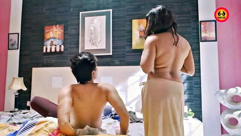 Indian maid topless from back in wrap skirt with shirtless man on bed