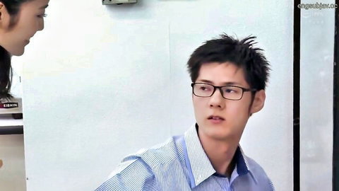 Young skinny Japanese wife with long hair gazes at handsome husband in glasses standing close